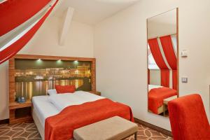 吕贝克吕贝克H + 酒店的一间卧室配有一张大床和镜子