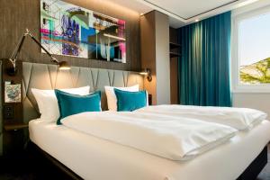 柏林柏林哈克市场一号汽车旅馆的卧室配有带蓝色枕头的大型白色床