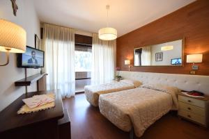 瓦尔迪佐多可乐娜酒店的酒店客房,设有两张床和镜子