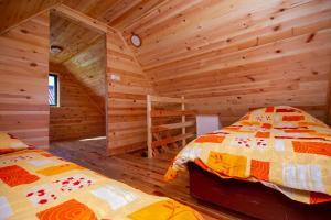 兹拉蒂博尔Brvnara Kovacevic的小木屋内一间卧室,配有两张床