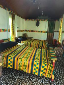 ButreGreen Zion Garden的一间卧室配有两张带彩色毯子的床