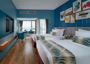 深圳深圳圣淘沙酒店公寓桃园店的两张位于酒店客房的床,拥有蓝色的墙壁