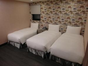 台北趣旅馆．林森馆的砖墙客房的两张床