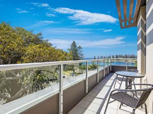 凯阿玛Sebel Harbourside 301 Kiama的阳台配有桌椅,享有海景。