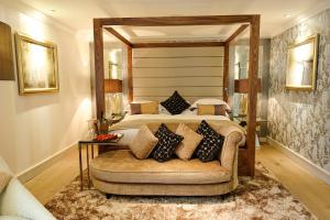 普尔福德格罗夫纳普尔福德酒店及Spa的一间卧室配有一张大床和一张沙发