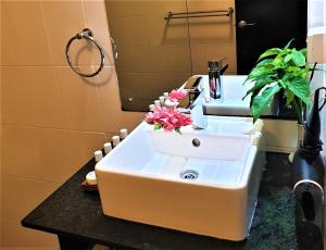 苏瓦苏瓦汽车旅馆的浴室内装有鲜花的水槽