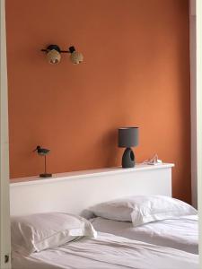 勒特雷波尔L’Estacade的卧室配有一张床上,墙上挂着鸟