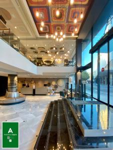 塞维利亚塞维利亚美洲酒店的大楼的大堂,里面设有一个游泳池