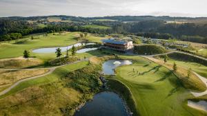 KácovPanorama Golf Resort的享有高尔夫球场空中景色,设有一座大楼