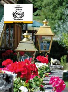 布朗托姆维格纳格红磨坊酒店的花园中两盏灯和鲜花,有标志
