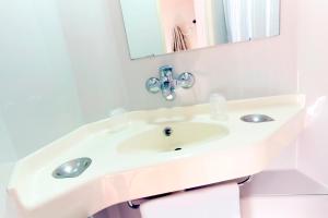 Parçay-Meslay克拉西图尔斯诺尔迪普瑞米尔经典酒店的白色的浴室设有水槽和镜子