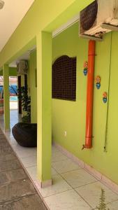 若昂佩索阿卡博布兰科酒店的房屋一侧有轮胎的绿色墙