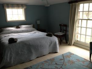 布里奇诺斯Duken Courtyard Cottage的一间卧室设有一张大床和两个窗户。