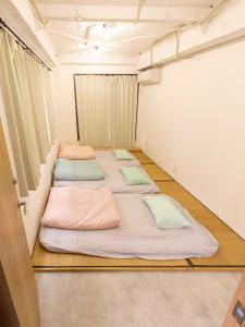 东京Guesthouse Sensu的房间里的一排床