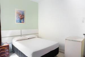 OYO Hotel Guarany客房内的一张或多张床位