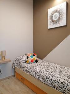 蒙泰卢波菲奥伦蒂诺La Casa delle Rondini的一间小卧室,配有一张床和墙上的照片
