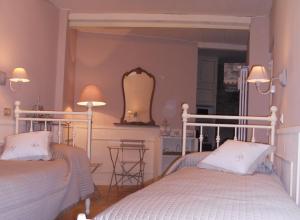 贝加莫圣特拉思默住宿加早餐旅馆的一间卧室配有两张床和镜子