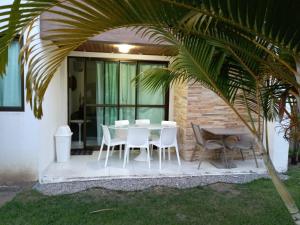 拉巴拉德纳圣米格尔ILOA Residence Apt Completo的一个带桌椅和棕榈树的庭院