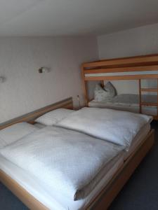 沃尔肯施泰因Ferienhaus Andrea Höcherl的一间卧室配有两张带白色床单的床
