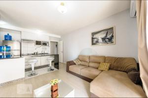 坎皮纳斯Dot Home Guanabara - Lindo Apartamento Mobiliado em Campinas的带沙发的客厅和厨房