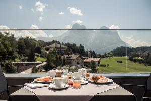 卡斯特尔罗托Hotel Alpenflora的一张带餐盘的桌子,享有山景