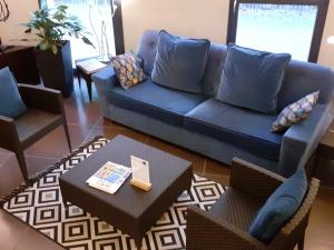 艾格-莫尔特艾格莫特运河酒店的客厅配有蓝色的沙发和桌子