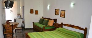 萨尔塔查瓦斯公寓式酒店的一间卧室配有一张床、一张沙发和一张桌子