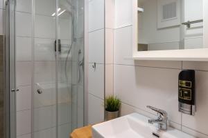 内卡苏尔姆Hotel Post mit Klimaanlage的一间带水槽和淋浴的浴室