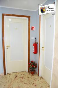 塔兰托B&B Tanese的一间有两扇门的房间,墙上有消防栓