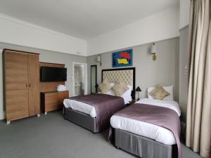 伦敦蓝铃酒店的酒店客房设有两张床和电视。