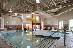 雷姆贝Quality Inn & Suites的大楼内一个带滑梯的游泳池