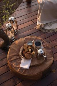 马迪克韦狩猎保护区Madikwe Hills Private Game Lodge的木甲板上的桌子上放着一盘食物