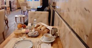 波尔图Poveira Hotel的桌子,上面放着一盒面包和一杯咖啡
