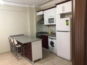埃利特温泉阿尔马萨套房公寓的厨房配有白色冰箱和洗碗机。