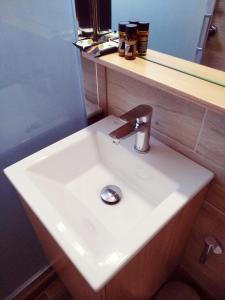 阿吉亚努美利卡里普索酒店的浴室设有白色水槽和镜子