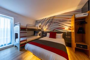 卡迪夫加的夫安睡者酒店的一间卧室配有一张床和一张双层床。