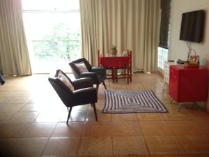 伊通比亚拉贝拉里约宾馆的客厅配有桌椅和电视