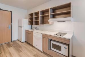 里奇兰WoodSpring Suites Tri-Cities Richland的厨房配有白色冰箱和水槽