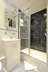西卢港老桥楼旅馆的带淋浴和盥洗盆的白色浴室