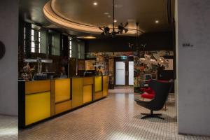 悉尼The Old Clare Hotel, Independent Collection by EVT的大堂设有黄色柜台和红色椅子