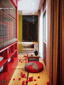 下龙湾Zen Hotel Hạ Long的一间铺有红色枕头和鲜花的客房