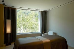 旌善PARK ROCHE Resort & Wellness的客房设有床和大窗户。