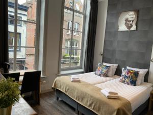 奈梅亨Hotel de Prince的一间卧室设有两张床和窗户。