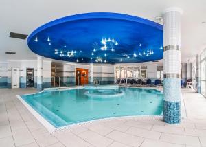 豪伊杜索博斯洛白银酒店的蓝色天花板建筑中的一个大型游泳池