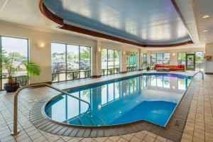里维尔洛根国际机场康福特茵旅馆&套房酒店的一座游泳池,位于一座带窗户的大房间内