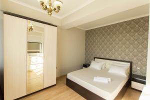 阿拉木图Residential Сomplex Central 270的卧室配有白色的床和镜子