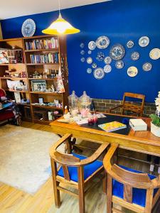 布隆方丹Bella Blue Guesthouse的墙上的餐桌和盘子用餐室