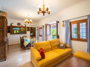 圣卡洛斯托尼马里别墅的一间带黄色沙发的客厅和一间用餐室