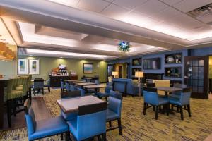 Dickson City迪克森市智选假日酒店的一间配备有桌子和蓝色椅子的用餐室
