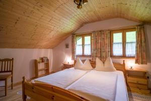 奥博奥多夫Bergbauernhof Hinterseebach的一间卧室设有一张带木制天花板的大床